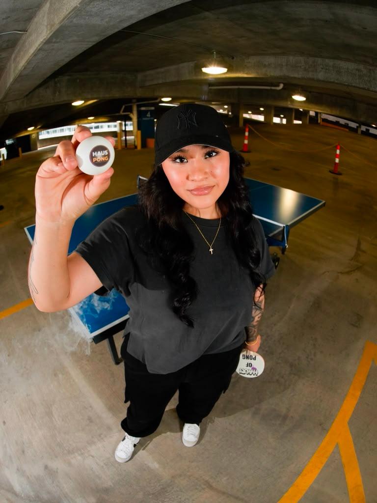 A player with a Haus of Pong paddle and ball in the underground lounge
